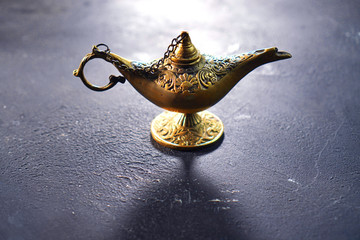 Bronze genie lamp on the vintage table