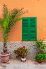 Fototapeta na wymiar Spanish house with green shutters in beautiful Majorca island. Balearic architecture. Spain