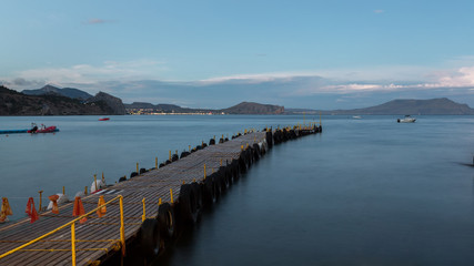 Fototapeta na wymiar mooring in the bay, floating pier, a long pier