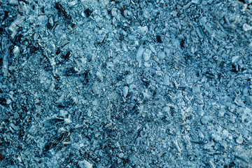 Ashes texture, may use as a background. Natural fire ashes with dark grey black coals texture. It is a flammable black hard rock. Space for text.