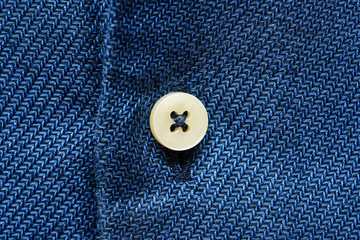 Blue shirt fabric with button. Textile background