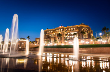 Emirates palace in Abu dhabi reflected on the ground level fountain