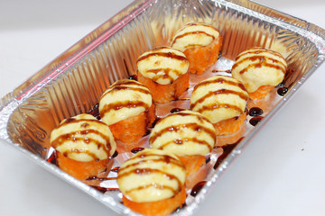 ready-made sushi with salmon in a box on a white table