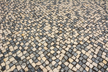 Fototapeta premium Abstract background of old cobblestone pavement view from above. Stone pavement in perspective. Cement floor background. Paving of the old town, pavement, texture