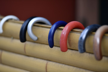 Colorful handles from different umbrellas hanging on a bamboo fence in Osaka-Japan.