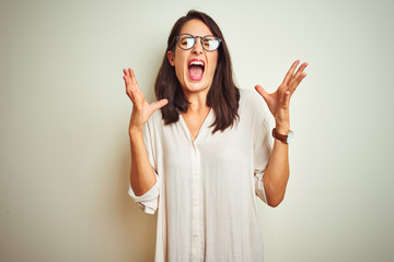 Young beautiful woman wearing shirt and glasses standing over white isolated background thinking looking tired and bored with depression problems with crossed arms.