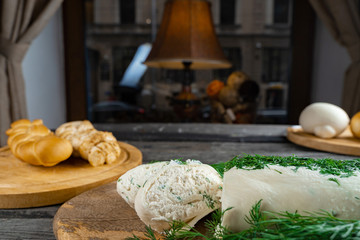 Cheese tablet with dill closup over restourant view