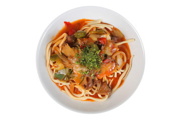 Pasta with meat and sauce on white plate top view