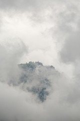 Mountain in the clouds, clouds cover the mountain peak
