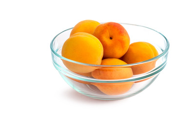 Apricot. Ripe Organic Apricots in blue transparent plate. Isolated on white background.