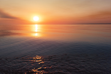 early morning sunrise on a choppy river / wind early spring landscape