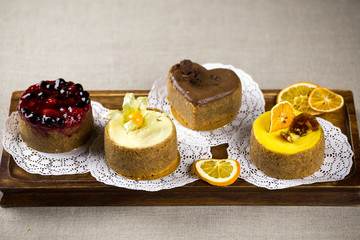 berry cake, lemon cake, cheesecake, desserts on a tray