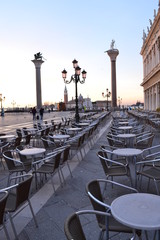 Dawn on Piazza San Marco in Venice. Still empty tables in the cafe.