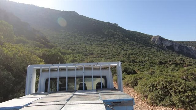 A lorry rides along a mountain road on the Mediterranean coast on a sunny summer day. Farmers in Turkey transport cargo