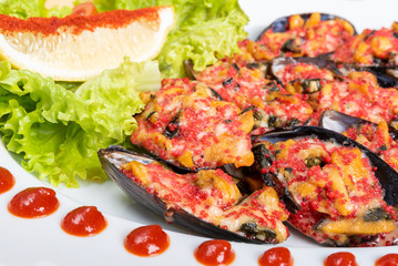 Baked mussels in half shell with filling and side dish.