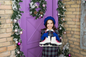 Professional skating equipment. Winter leisure. Cute skates. Active and fun. Small child hold...