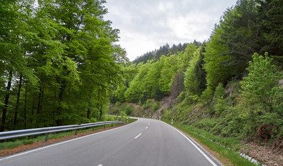 Beautiful asphalt road with turns through the Schwarzwald forest in Germany