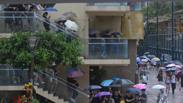 hong kong august 2019 protests. Massive crowds of protesters carry umbrellas on building ladder in central Hongkong during rainy weather, peaceful assembly and anti government demonstrations