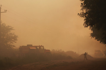 Fototapeta premium fire in a garbage dump, smoke and waste