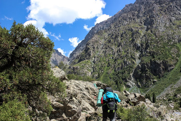 trekking in the mountains, people with backpacks, tian shan, Kyrgyzstan