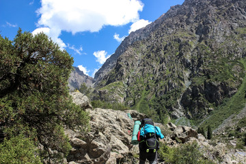 Naklejka premium trekking in the mountains, people with backpacks, tian shan, Kyrgyzstan