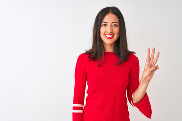 Young beautiful chinese woman wearing red dress standing over isolated white background showing and pointing up with fingers number three while smiling confident and happy.