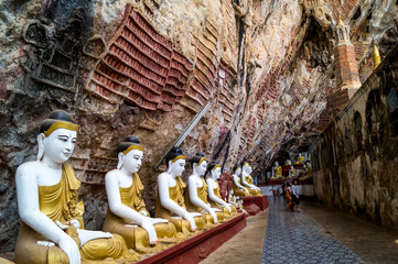 statues of buddha in a cave