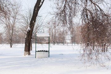 Winter. An old water well is covered in snow.