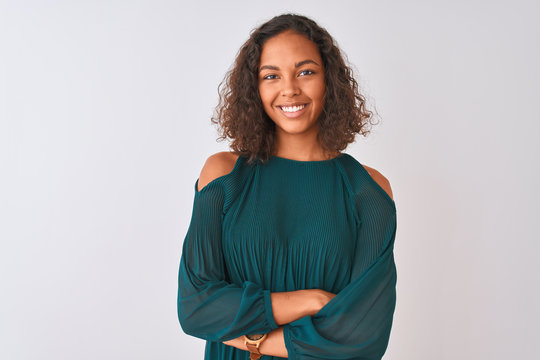 Young brazilian woman wearing green t-shirt standing over isolated white background happy face smiling with crossed arms looking at the camera. Positive person.
