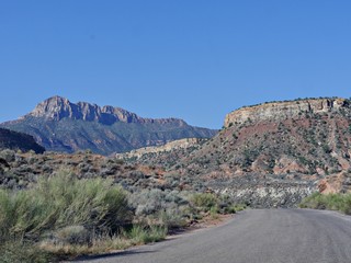 Back road and dramatic landscape of cliffs and rock formations few miles south of Zion National Park, Utah.