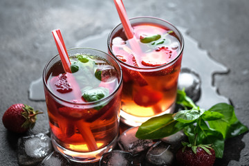 Homemade strawberry lemonade with basil on a dark background.