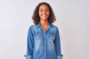Young brazilian woman wearing denim shirt standing over isolated white background with a happy and...
