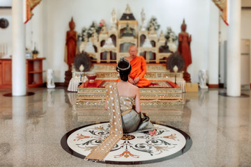 Asian woman The traditional Thai dress was blessed by monks,Sakonnakhon,Thailand.