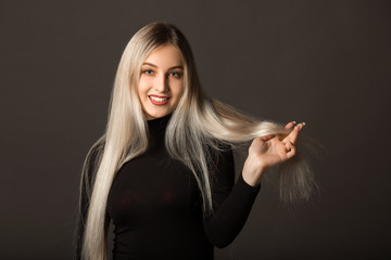 beautiful young woman with long hair on a black background