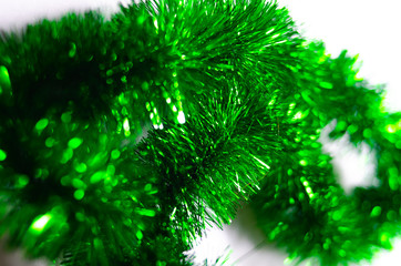 Green fluffy macro rain garland to decorate the Christmas tree on a merry Christmas holiday