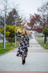 Beautiful girl in a dress on a city alley