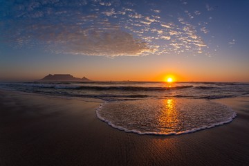 Sunset over the shore of the famous Table mountain in Cape Town, South Africa