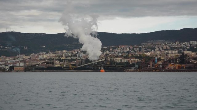 Industrial zone in Trieste city over bay seen from Muggia, Italy
