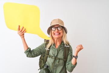 Senior hiker woman wearing canteen holding speech bubble over isolated white background screaming proud and celebrating victory and success very excited, cheering emotion