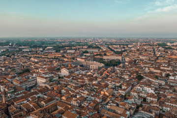 Aerial drone shot view of sunrise on historic Verona city center with red brick city skyline