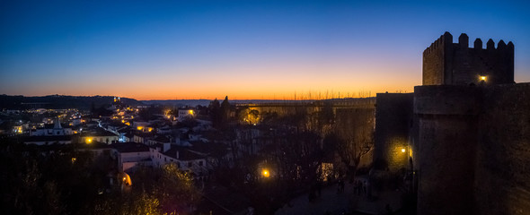 Sunset view of the old town walls, decorated for Christmas, in Obidos, Portugal