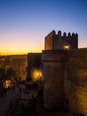 Sunset view of the old town walls, decorated for Christmas, in Obidos, Portugal