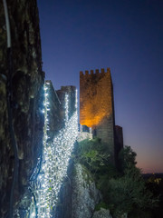 Sunset view of the old town walls, decorated for Christmas, in Obidos, Portugal