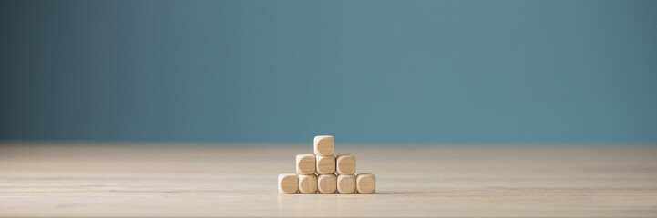Wide view image of blank wooden dices stacked in pyramid shape