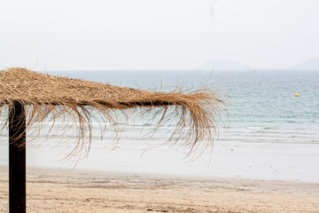 Sombrilla de paja a la orilla del mar