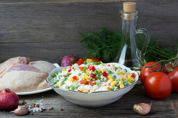 Cooking chicken with vegetables and rice.
