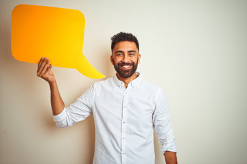 Young arab indian hispanic man holding speech bubble over isolated white background with a happy face standing and smiling with a confident smile showing teeth