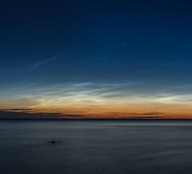 mesospheric clouds, silvery over the sea