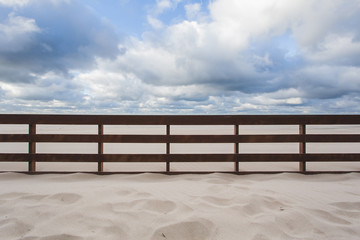 Fototapeta na wymiar wooden fence in the sand on the beach