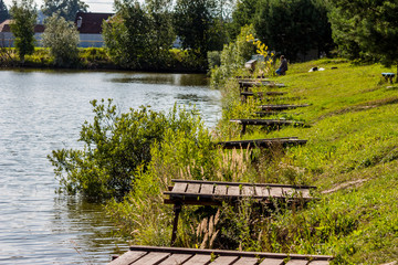 A row of fishing piers on the shore of a fishing pond